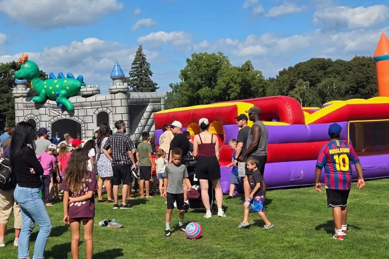 Families and kids at the inflatables and play area on the lawn at Jesus Festival Hamilton 2026